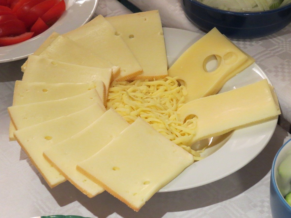 Cheese is organized on a plate.