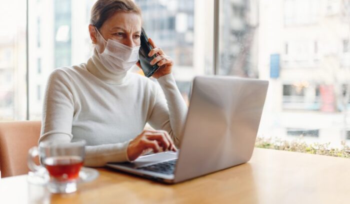 woman reading online mask gloves